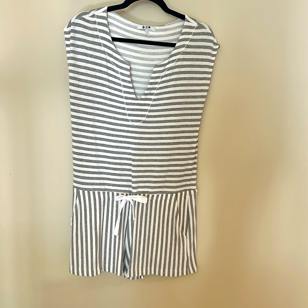 Gray and white striped romper with short sleeves.